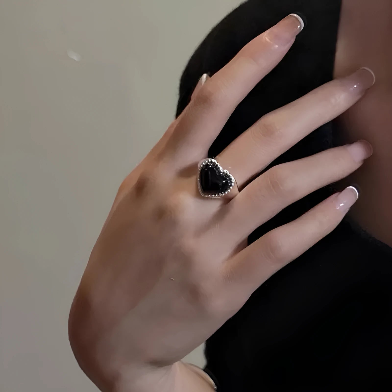 Adjustable open mouth sterling silver ring with a black heart-shaped agate stone.