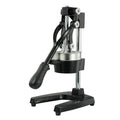 Black manual cast iron citrus juicer with stainless steel strainer on a kitchen counter.