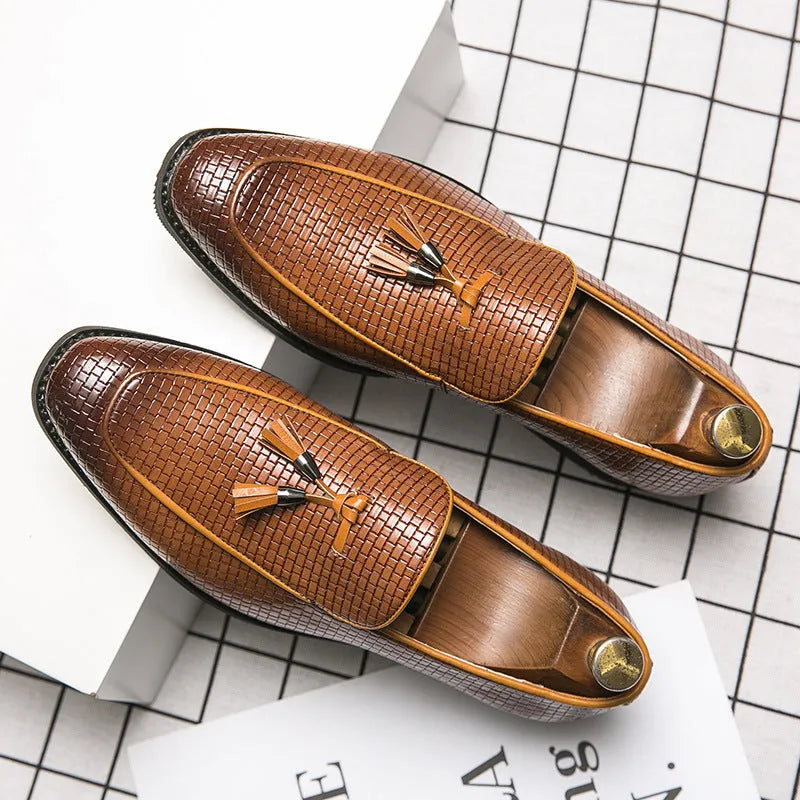 Men's black slip-on business shoes with pointed toe and tassel detail on artificial PU upper