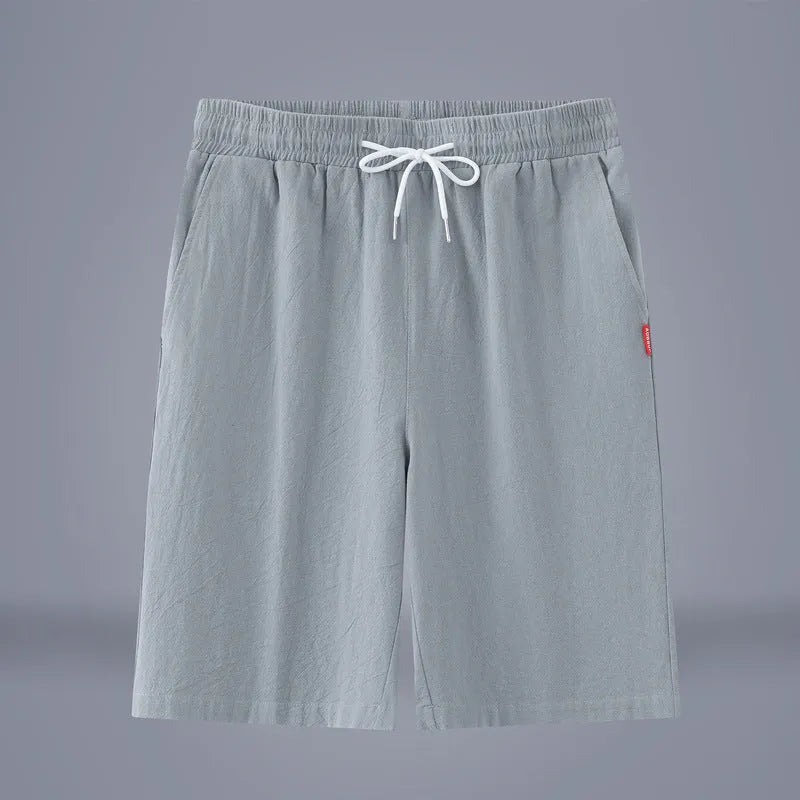 Solid colour cotton linen cropped summer pants on a hanger, showing mid-waist and drawstring detail.