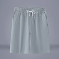 Solid colour cotton linen cropped summer pants on a hanger, showing mid-waist and drawstring detail.