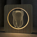 Tooth-shaped wood colour acrylic USB night light on a surface, showing compact size.