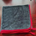 Twisted braid car cleaning towel for glass washing and automotive detailing in grey with red edge trim