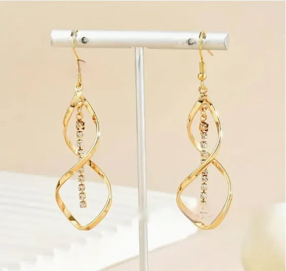 Gold-colour geometric earrings with a creative spiral and elliptical design for women.