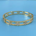 Gold or silver plated women's hollow bracelet with a four-leaf clover charm and zircon stones.