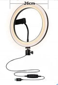 Adjustable aluminium telescopic phone stand extended to full height on a table.