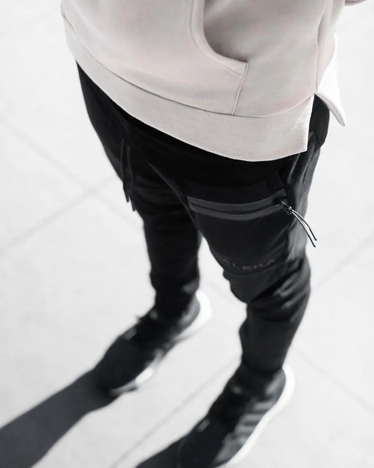 Men's black cotton joggers with elastic waist and velcro side pockets, loose fit, for sports and casual wear