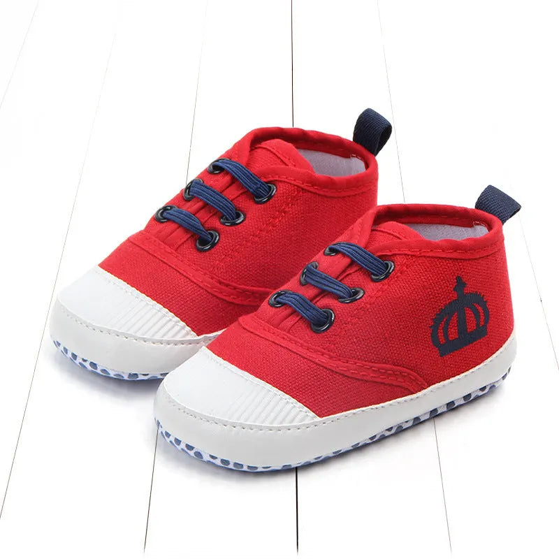 Canvas toddler shoes with elastic band in red and white on neutral background