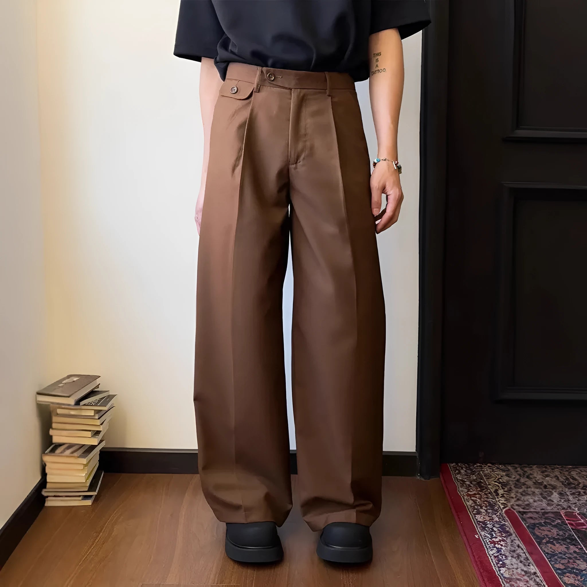 Men's straight-leg wide trousers in black, showing casual suit pant style with draping fabric.