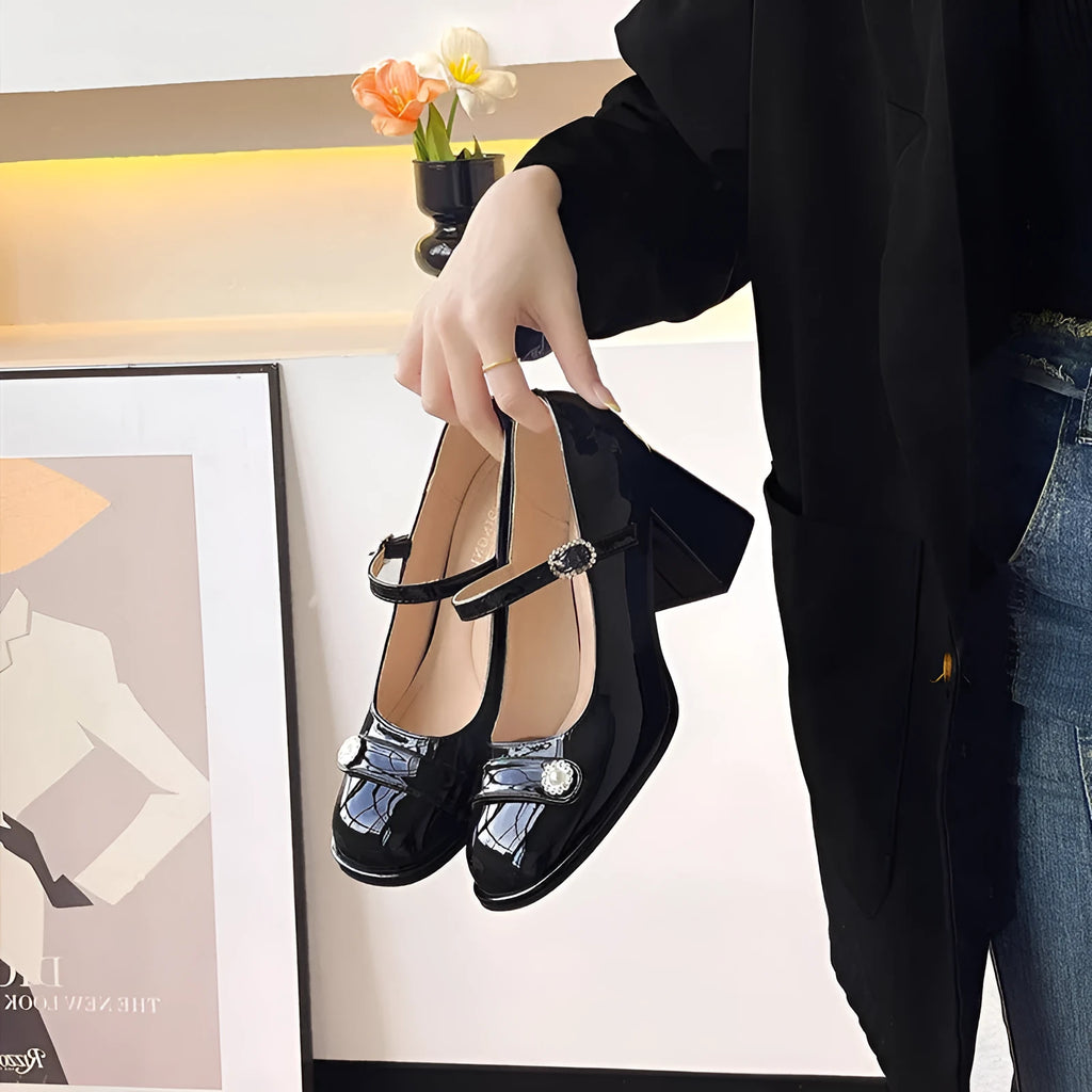 Women's black patent leather chunky heel round toe high heels with ankle buckle.