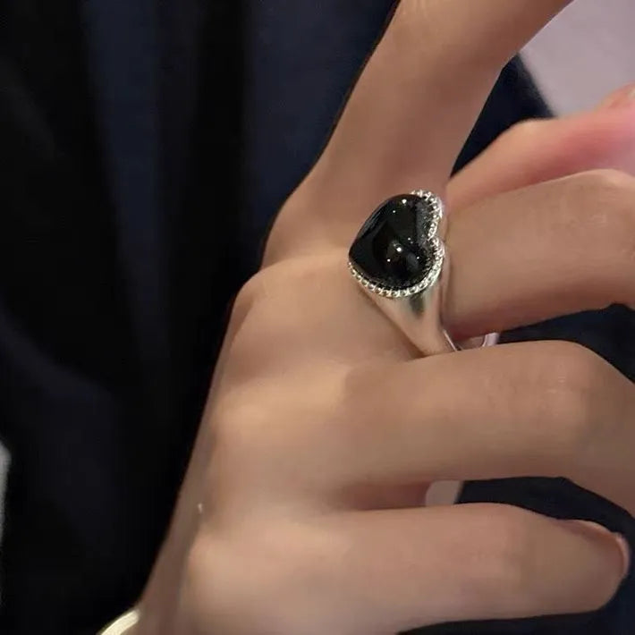 Adjustable open mouth sterling silver ring with a black heart-shaped agate stone.