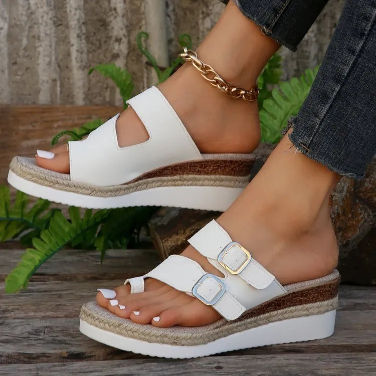 White patent leather wedge sandals with woven design and finger fit straps