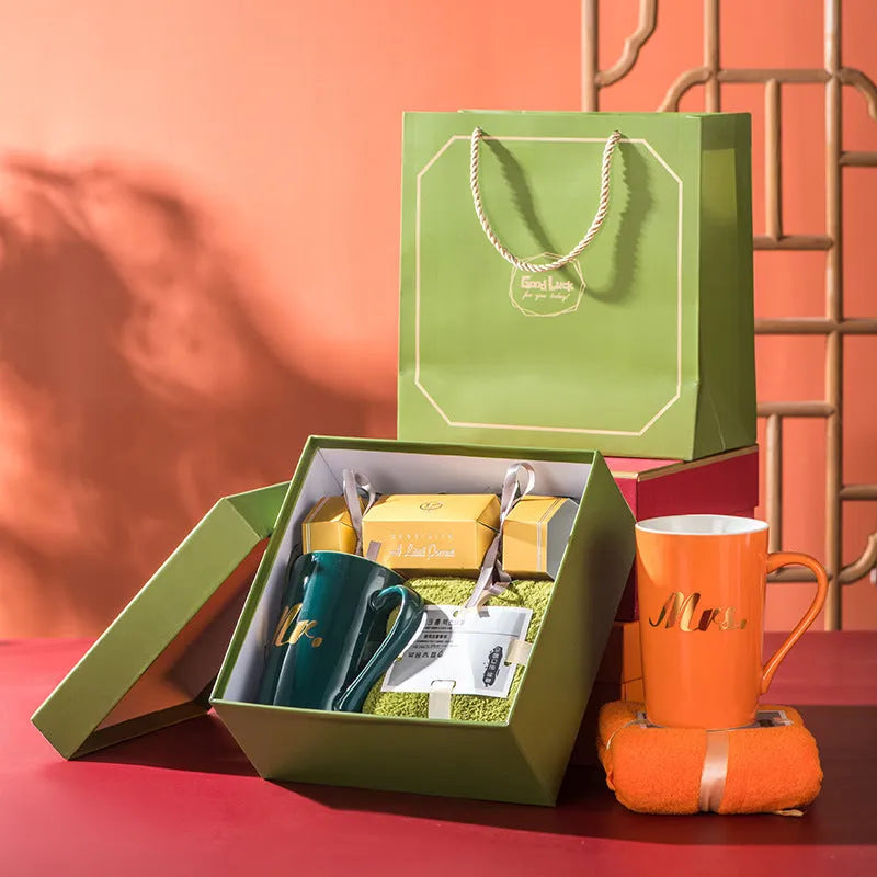 Light luxury ceramic cup gift box set with pink mug, candy, and towel on display