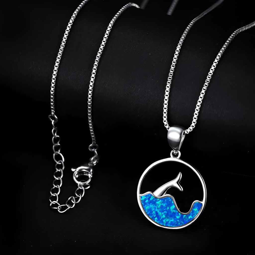 White gold electroplated geometric fishtail necklace pendant with a round blue opal stone.