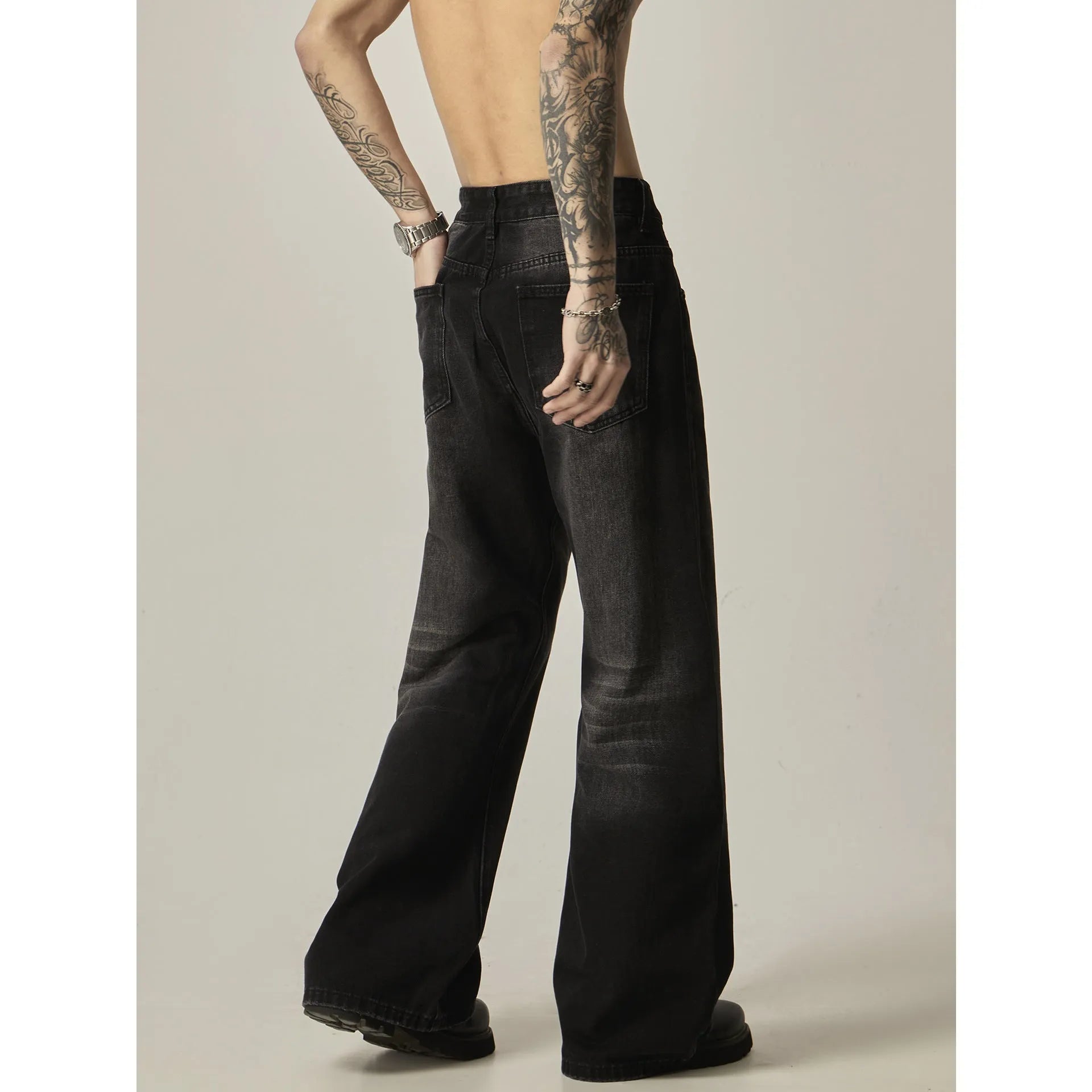 Black loose straight-leg retro jeans with zip fly opening on mannequin