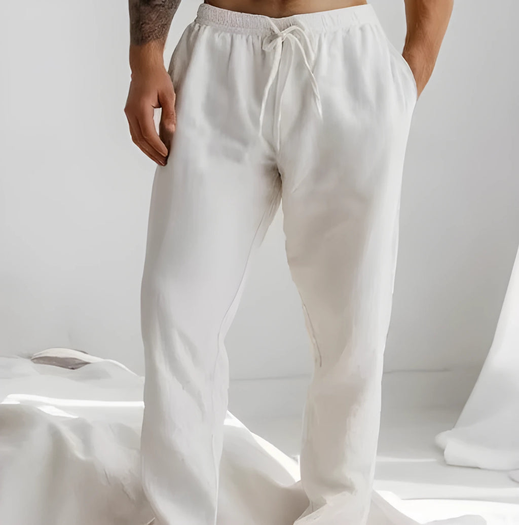 Men's loose-fit cotton linen trousers in light blue with an elastic drawstring waistband.