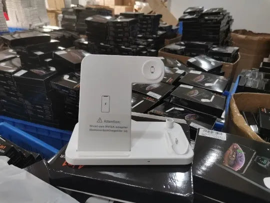 Folding 4-in-1 wireless charger showing iPhone, Apple Watch, and AirPods charging simultaneously in vertical stand orientation