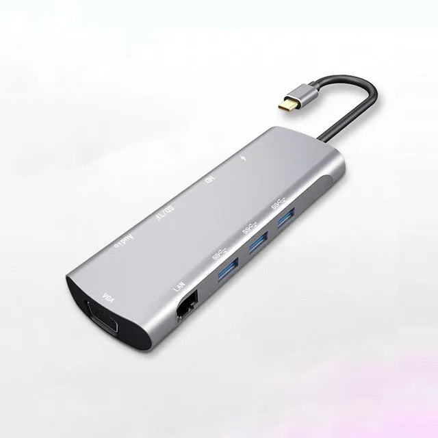 Grey aluminium USB-C docking station showing HDMI, VGA, USB 3.0, and USB-C PD charging ports.