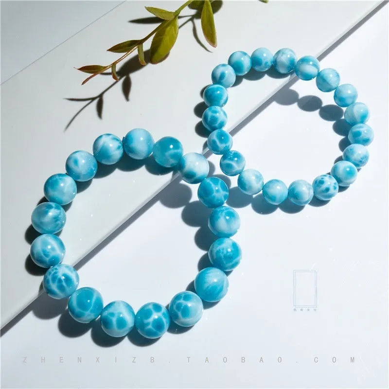 Blue handmade Bodhi bead bracelet with crystal sea-pattern stone and pearl accent on wrist