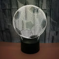 3D football-shaped acrylic night light glowing in blue with a black ABS base and remote control.