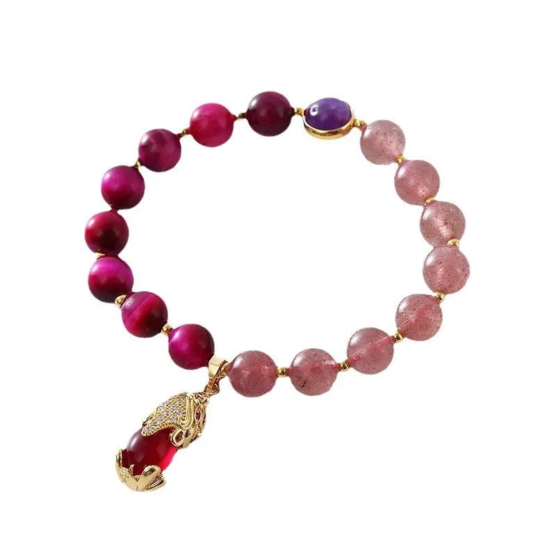 Strawberry crystal bracelet on wrist showing elastic rope construction and natural stone colour