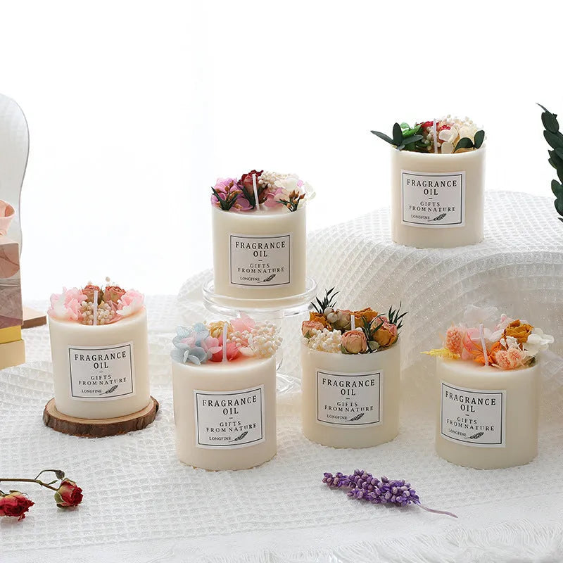 Decorative aromatherapy candle with dried flowers in wax, shown with optional wooden base and gift box.