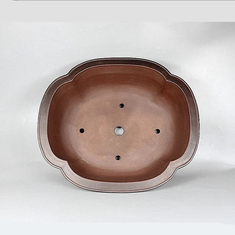 Large antique crabapple-shaped handmade purple clay flowerpot for plants.