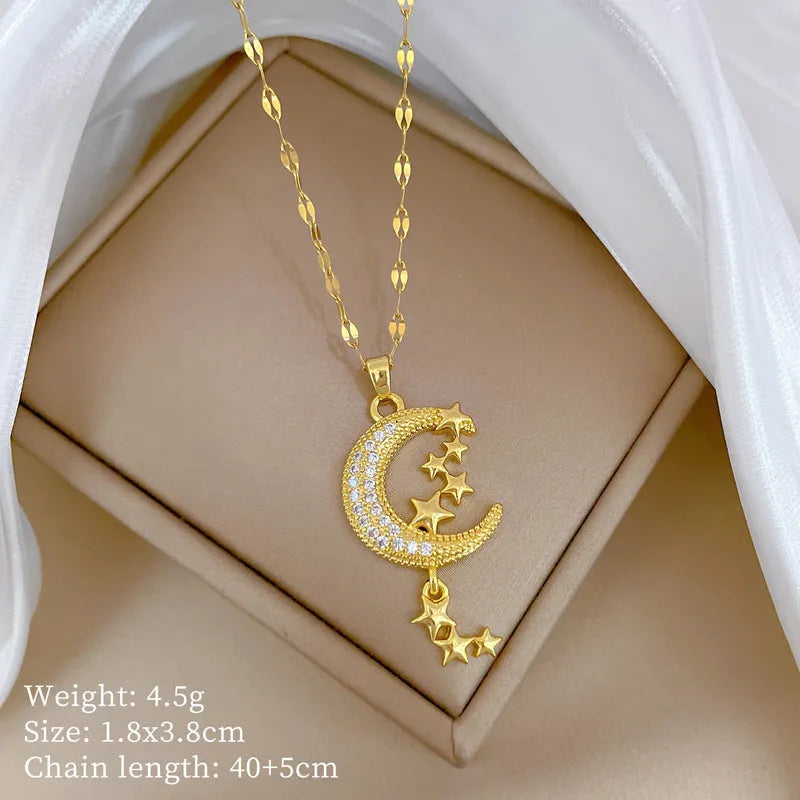 Moon pendant necklace with tassel design and diamond accents on stainless steel chain