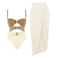 Women's solid colour one-piece swimsuit with detachable skirt and gold button detail in nylon fabric