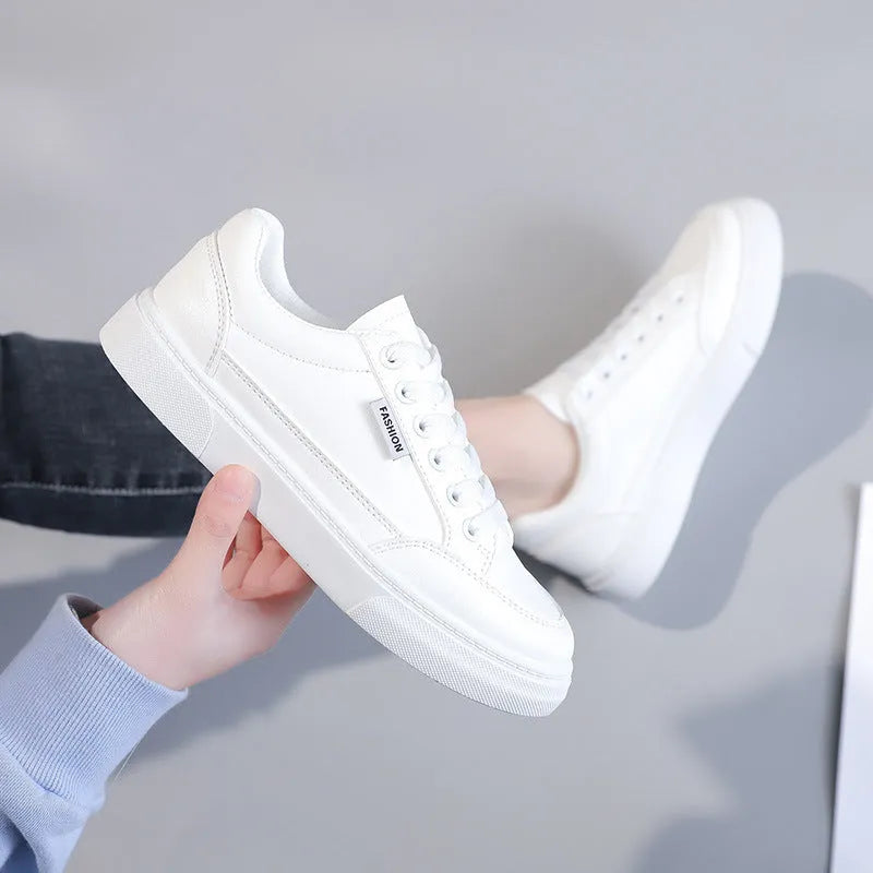 Korean-style white low-top women's sneakers made from artificial PU leather with a plastic sole.