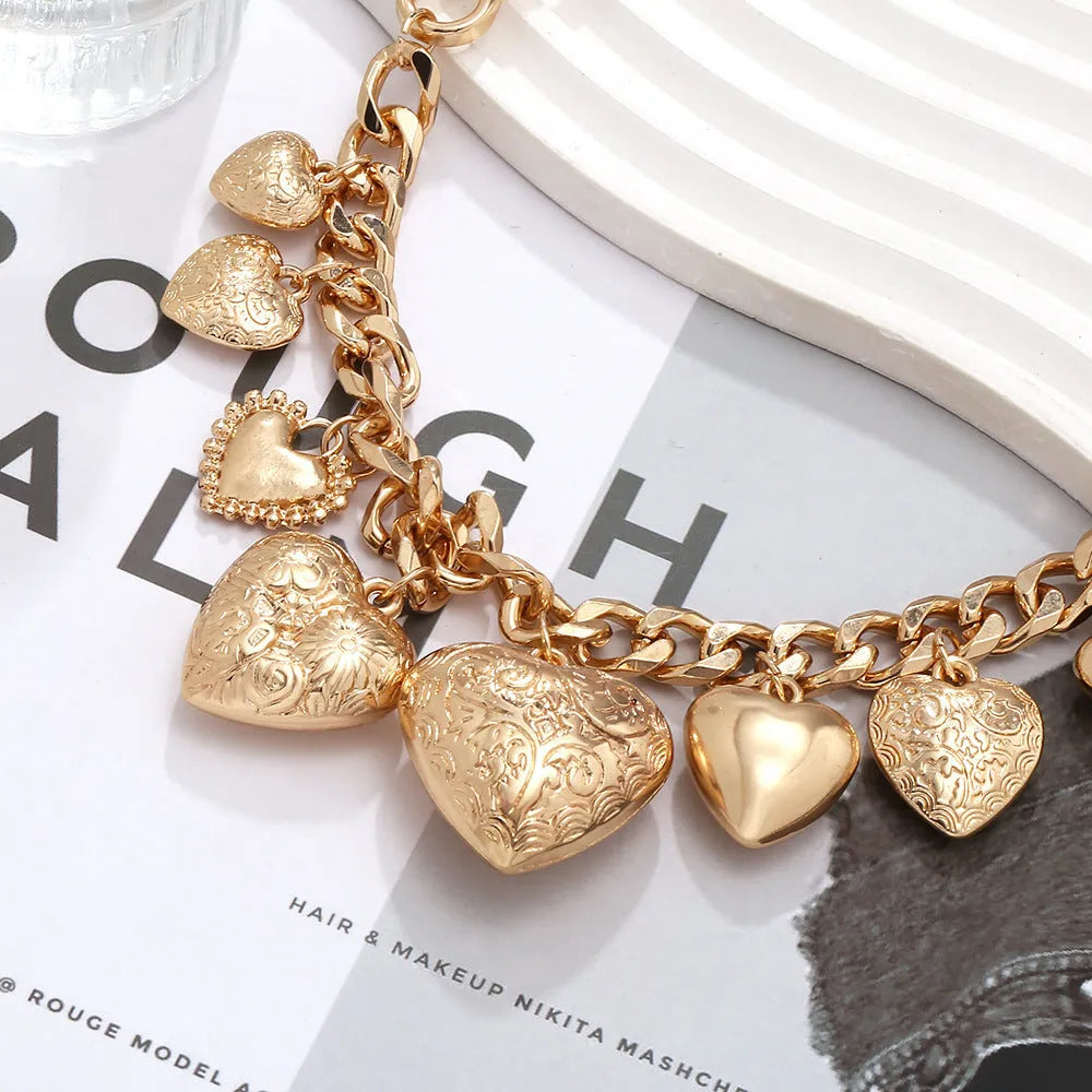 Exaggerated carved heart pendant necklace in gold finish with adjustable chain