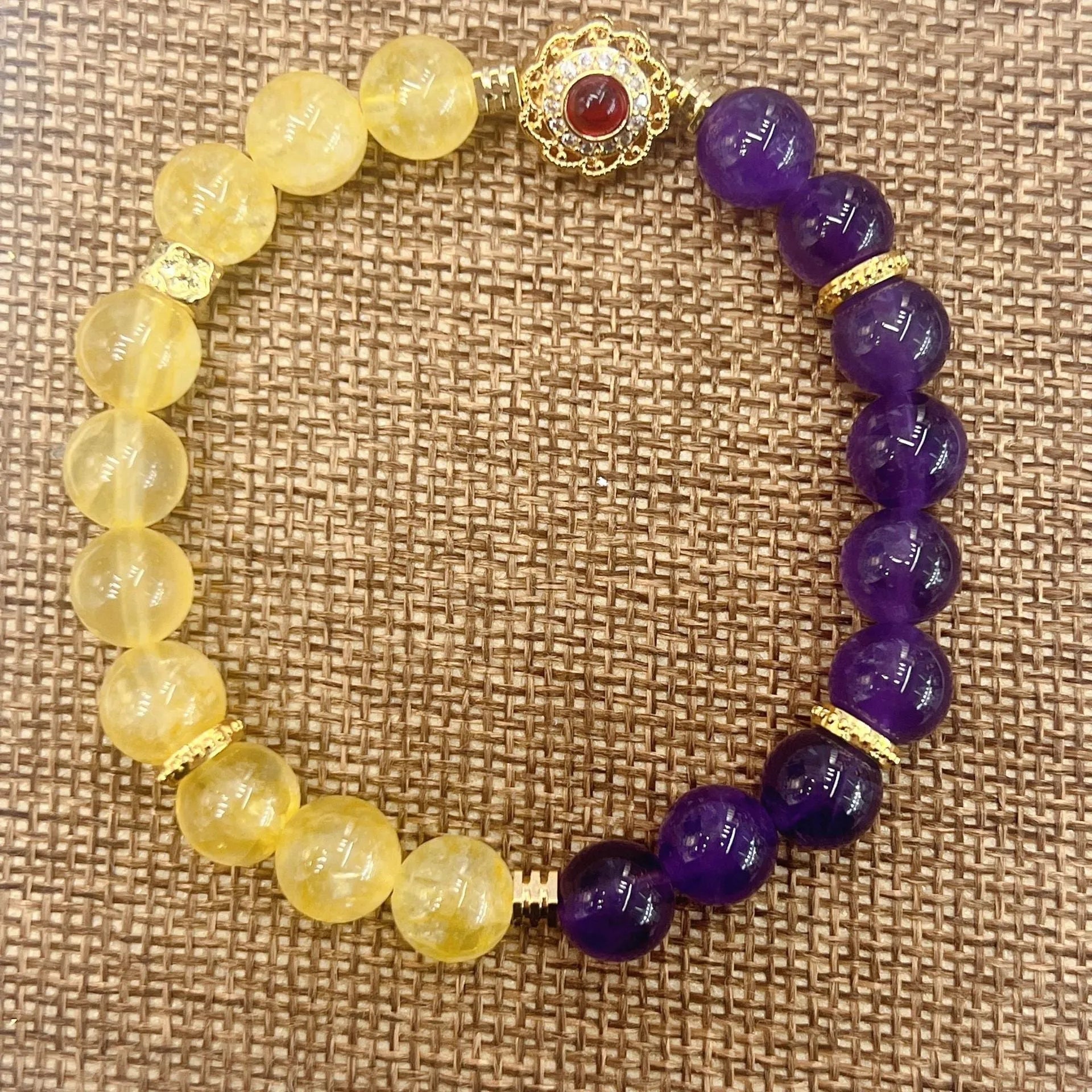 Handmade women's bracelet with yellow and purple crystal amethyst stones on adjustable clasp