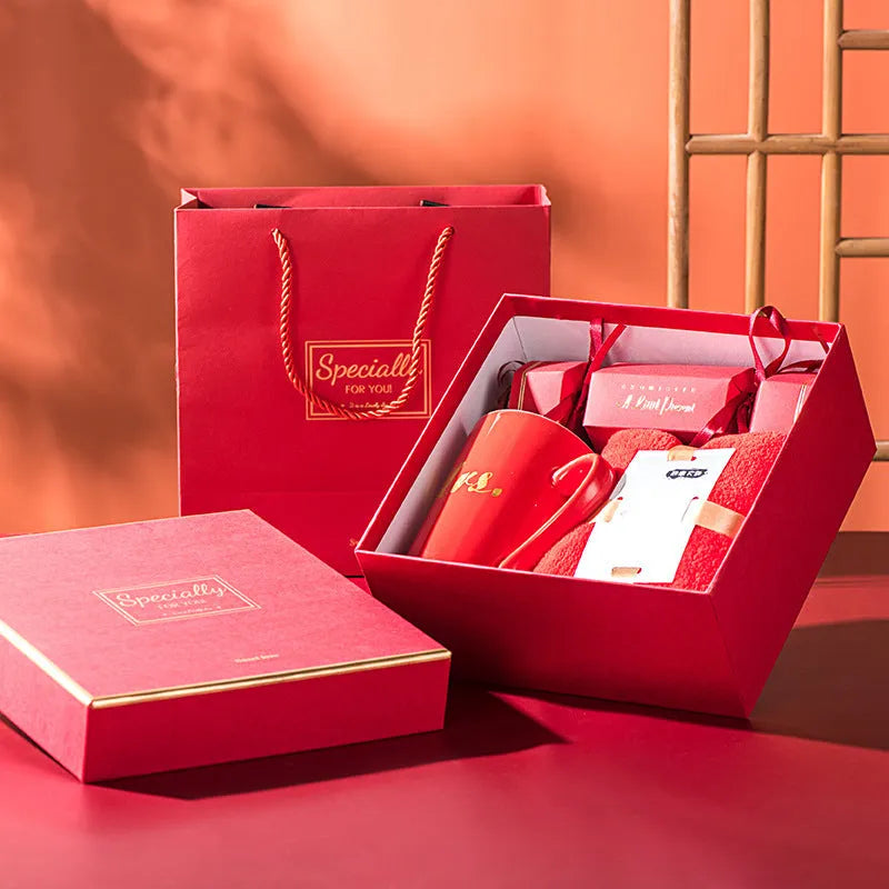Light luxury ceramic cup gift box set with pink mug, candy, and towel on display