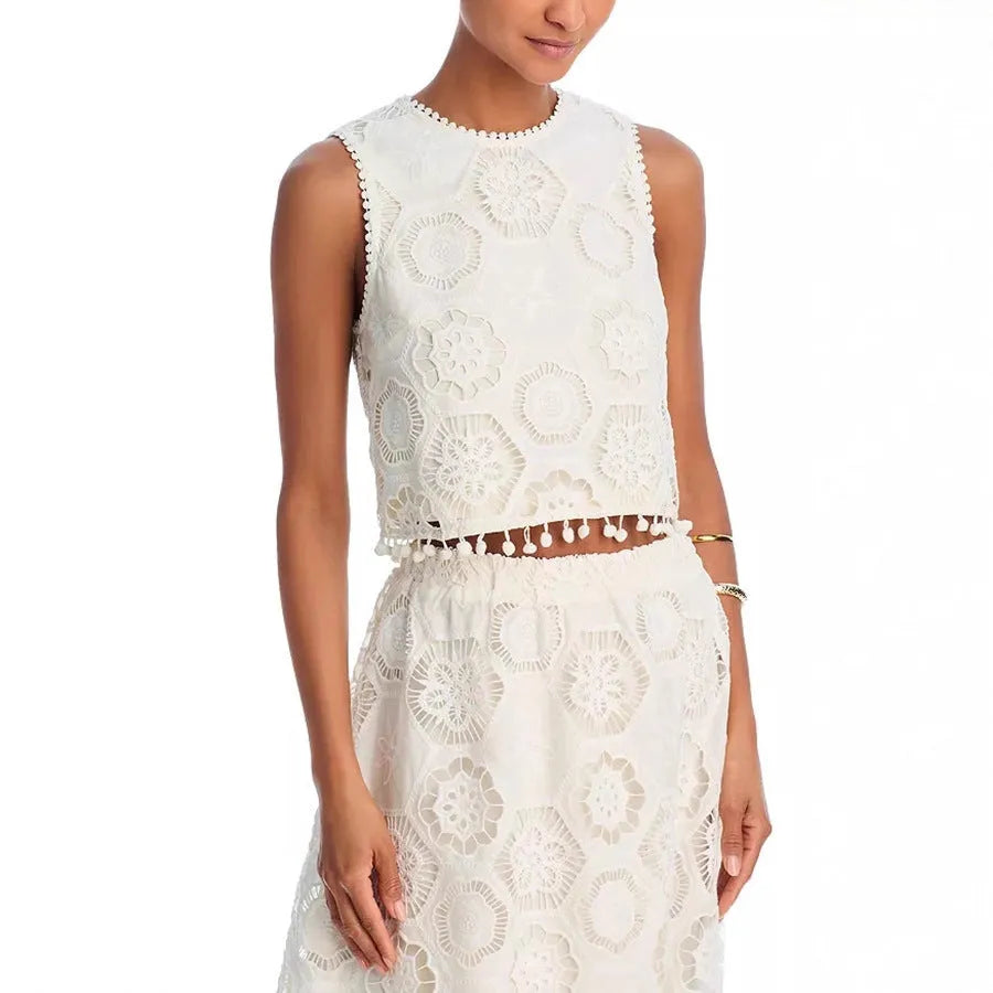 White women's retro suit with embroidery details showing sleeveless top and long skirt