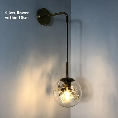 Modern glass wall lamp with minimalist design shown in bedroom setting