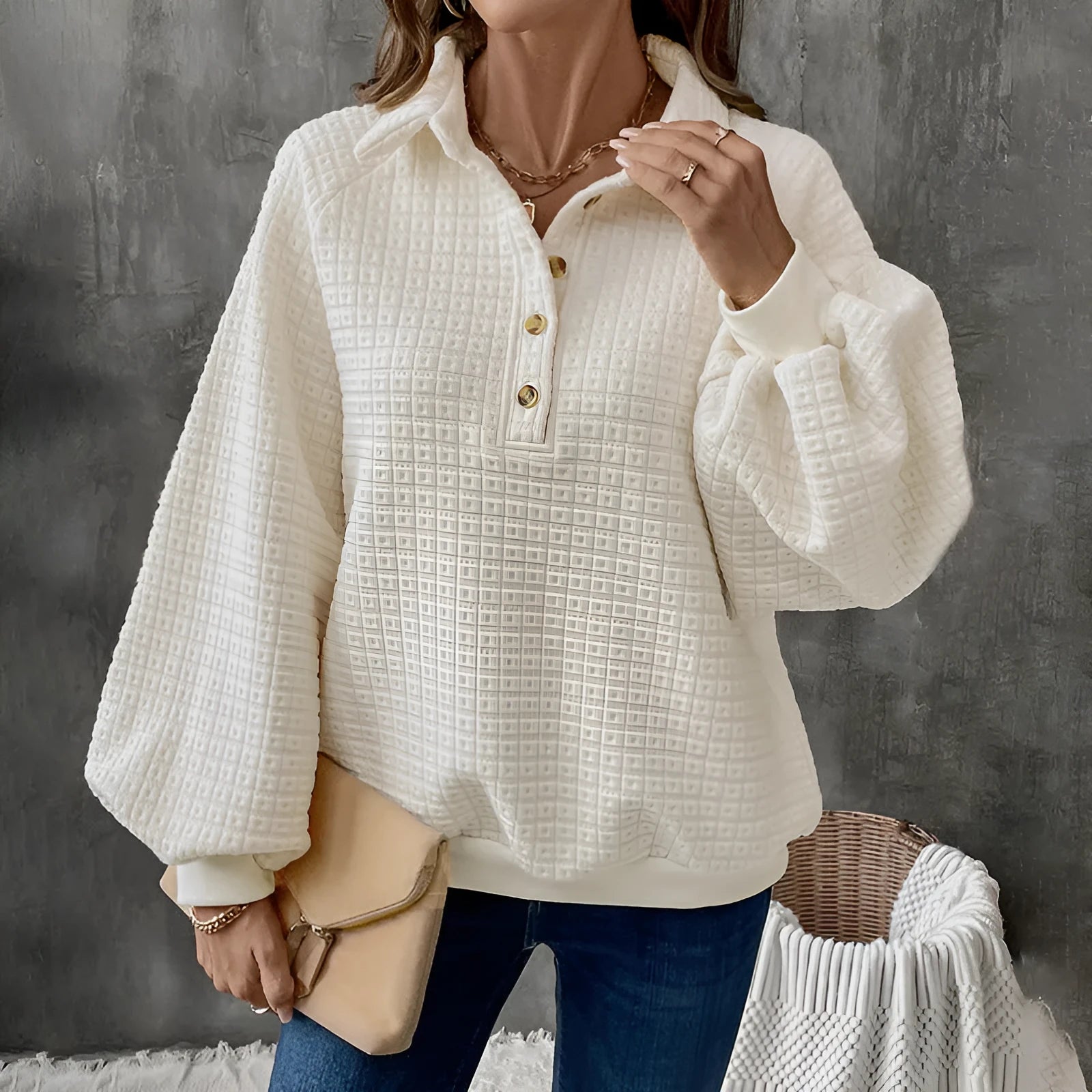 Women's beige textured polo collar long sleeve polyester sweater on a hanger.