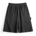 Cement grey polyester sports shorts with straight leg loose fit and elastic waistband