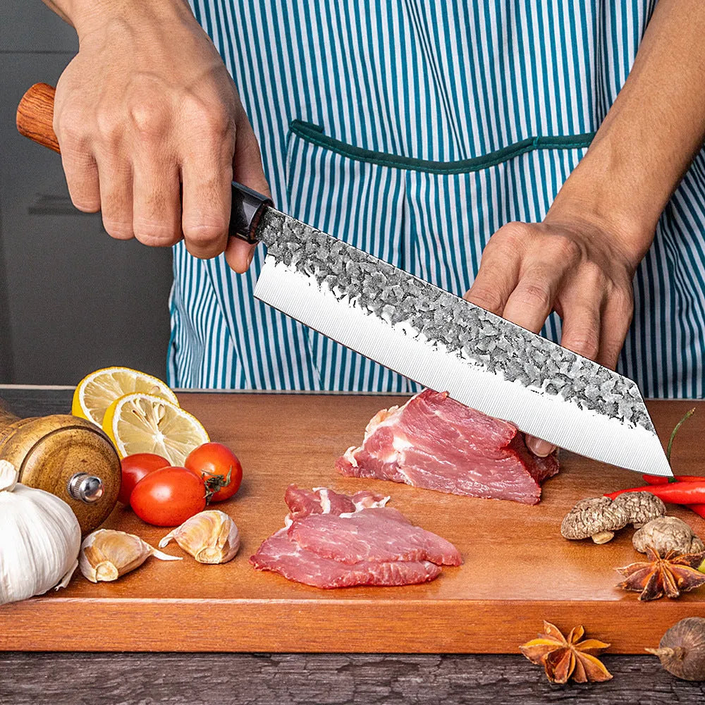 Handmade hammered forged stainless steel santoku chef knife with gift box packaging on a kitchen surface