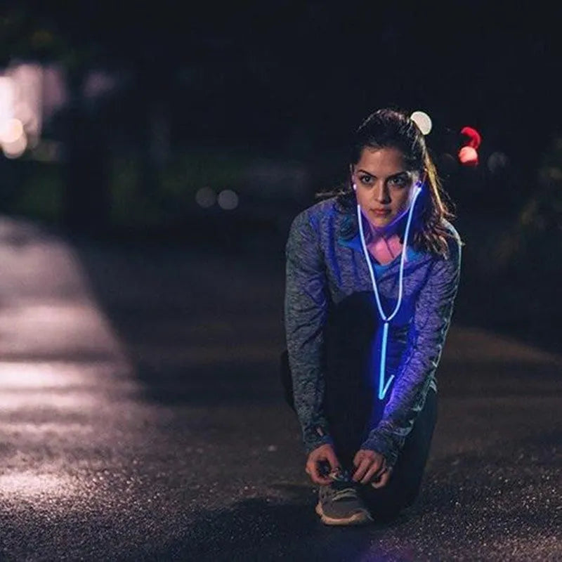 Blue LED light-up earphones with 3.5mm jack and in-line remote control on a white background.
