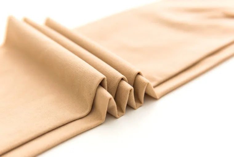 Beige stovepipe shaping socks for waist and hips on a neutral background.