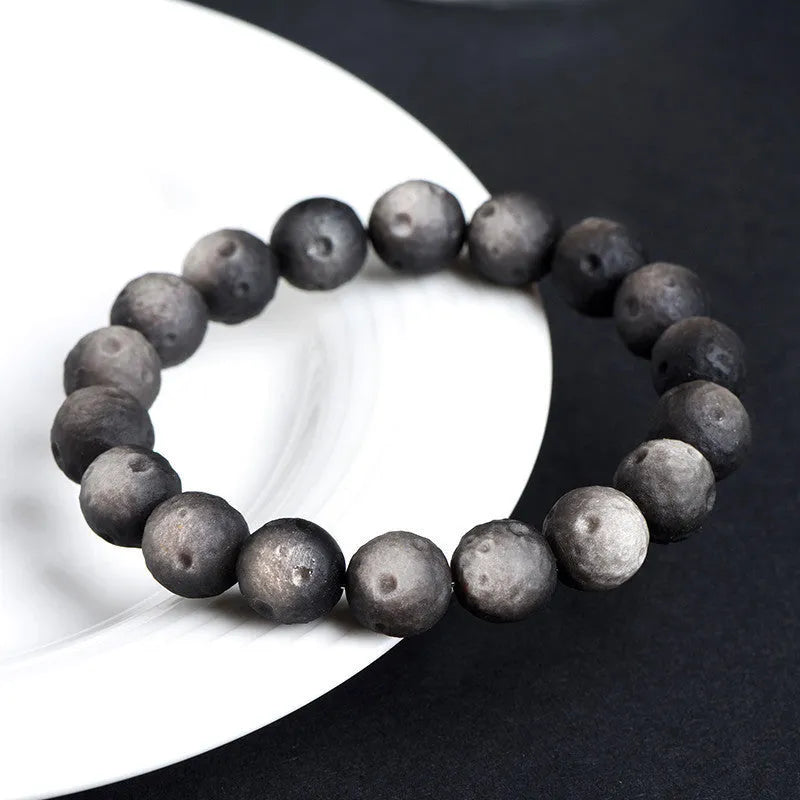 Obsidian crater ball bracelet with grinding texture in silver or golden meteorite colours