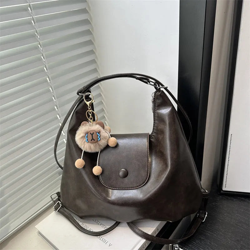 Textured PU leather shoulder bag in horizontal square shape with single strap and internal phone pocket