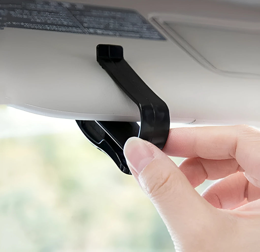 Black plastic car sunshade clip holder for glasses and tickets on a car visor