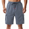 Men's loose fit cargo shorts with multiple pockets in terry fabric, shown in light grey colour