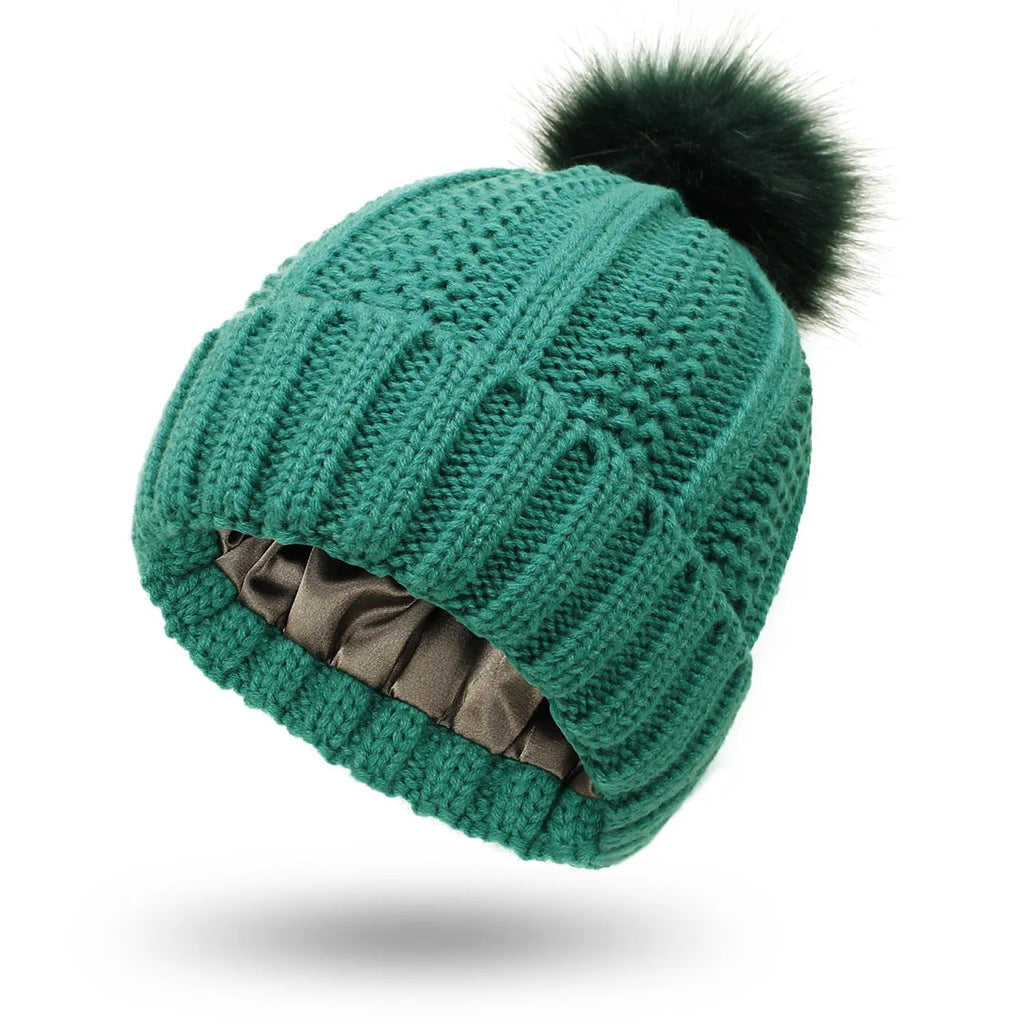Women's knitted beanie hat with satin lining in various colours on a mannequin head.