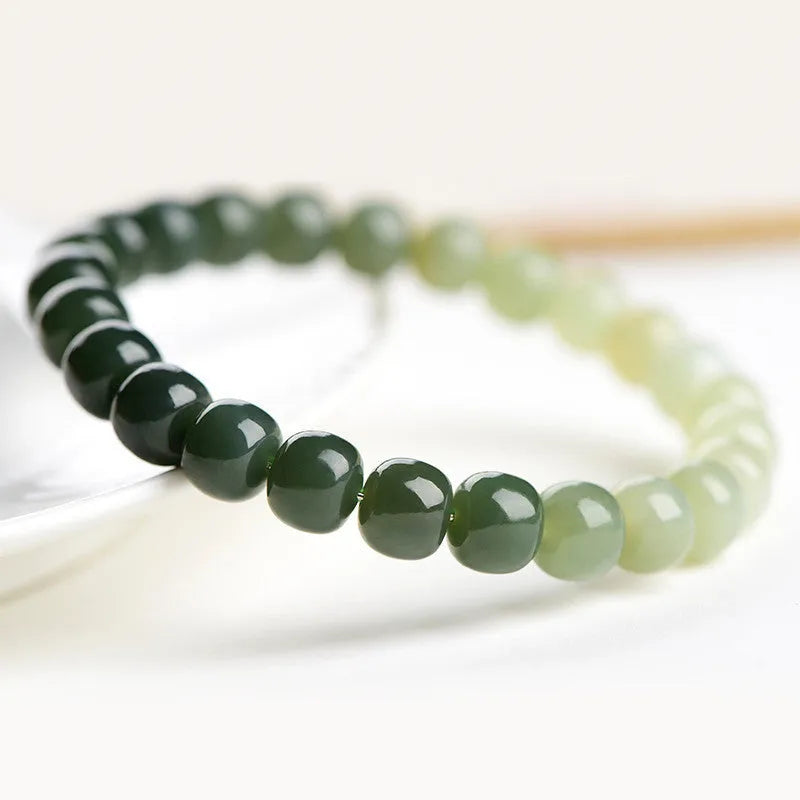 Natural Hetian jade bracelet showing a sunny water gradient colour on polished beads.