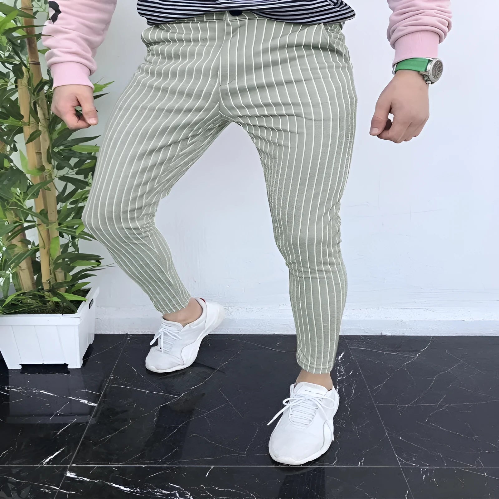 Man wearing slim-fit straight-leg plaid casual trousers in a striped pattern.
