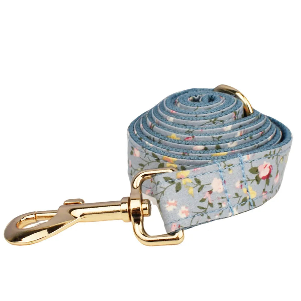 Blue floral polyester cotton dog collar set with matching leash, vest, poop bag, and decorative bow
