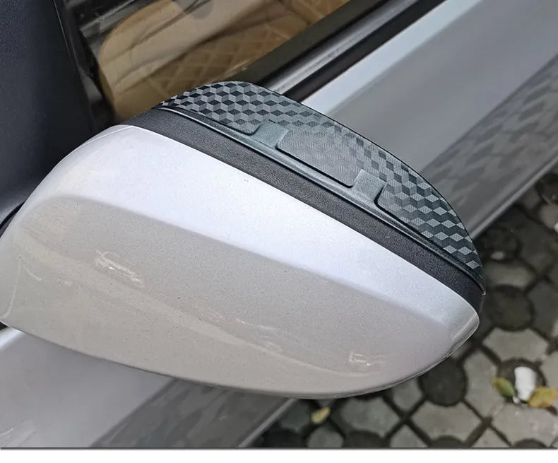 Pair of Mazda reversing mirror rain barrier strips in carbon fibre pattern on a Mazda CX5 side mirror