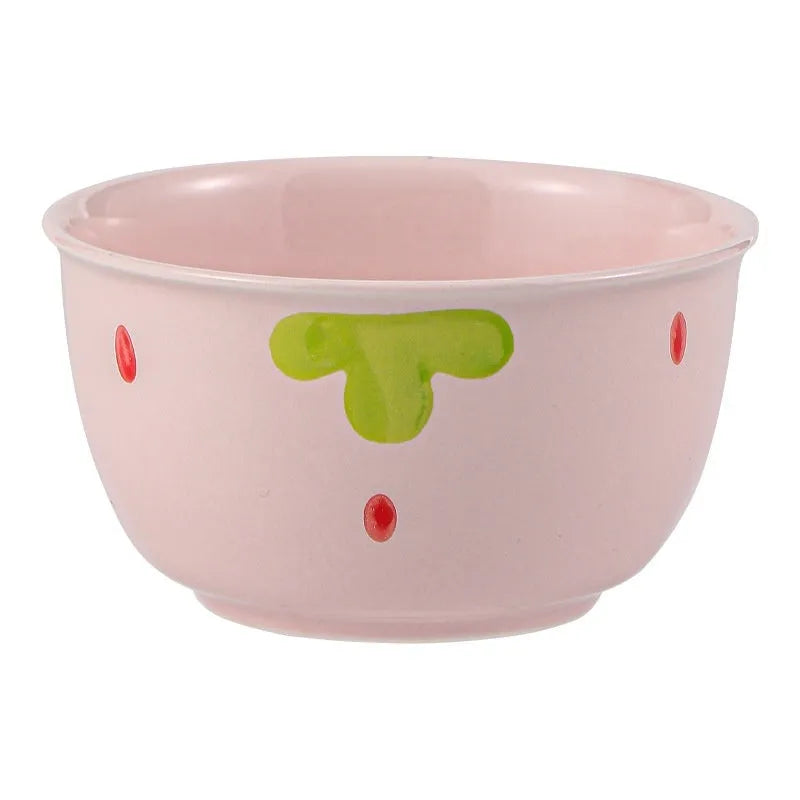 Porcelain dinnerware set with strawberry design: bowl, plate, and twist-handle spoon.